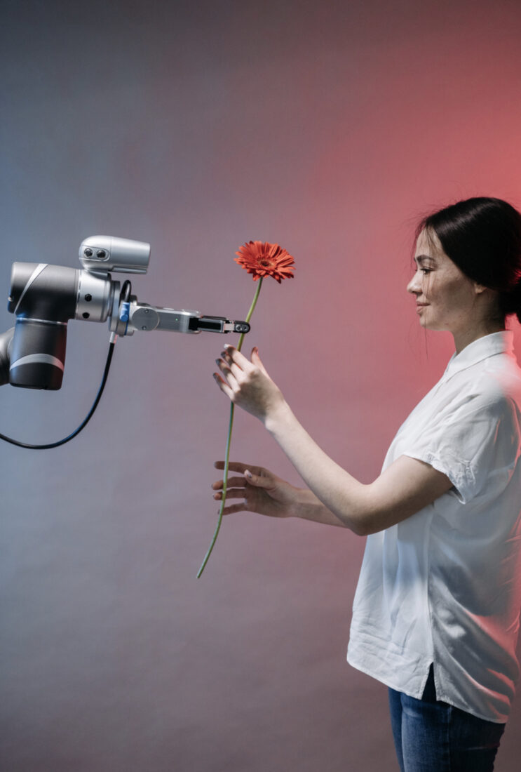 girl and AI robot with a flower.